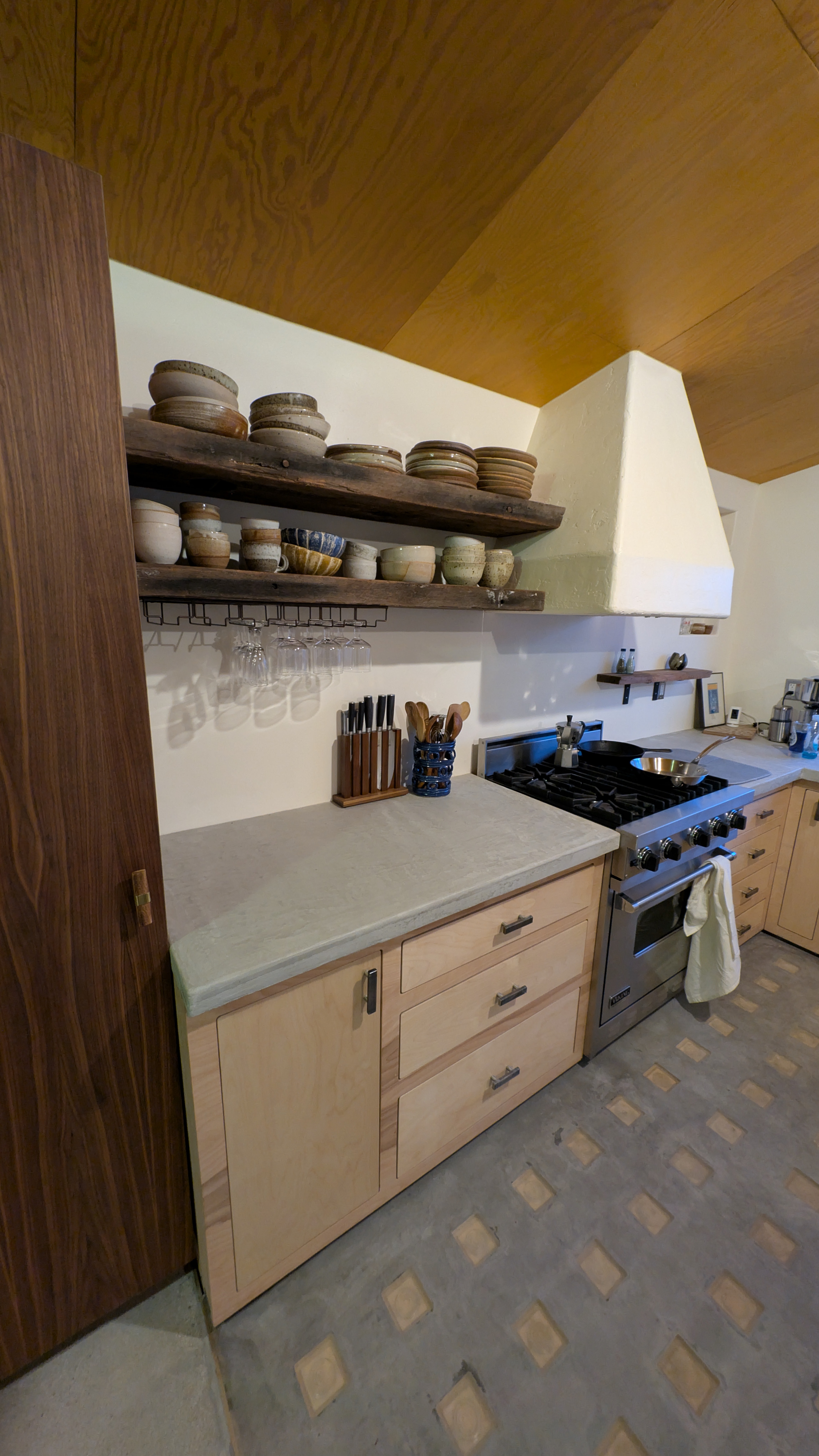 Industrial steel soaking tub on blue micro-cement base