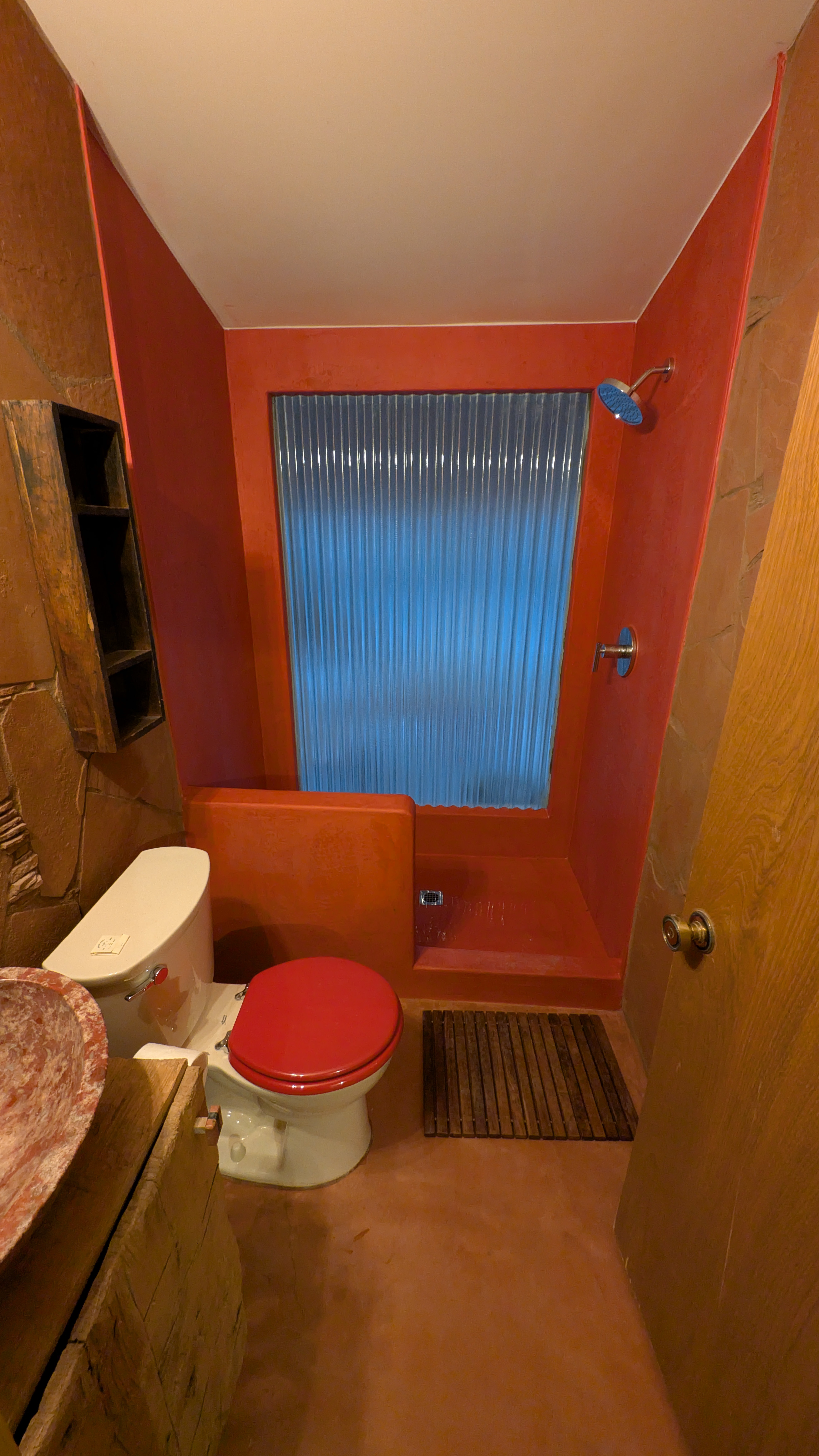 Kitchen with custom concrete circular island and wood ceiling