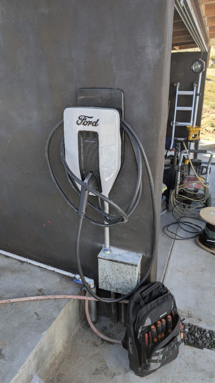 Ford Charge Station Pro Level 2 EV charger mounted on the exterior stucco wall