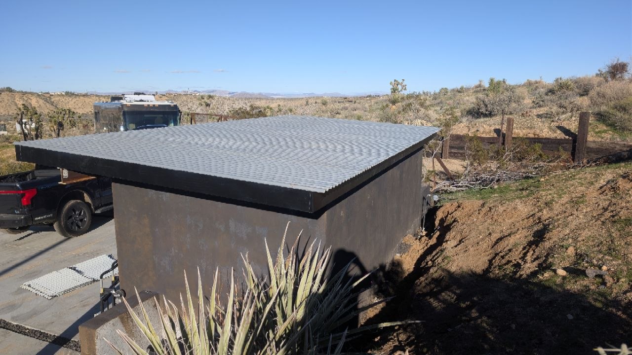 Aerial view of the completed shed against the open Joshua Tree desert landscape