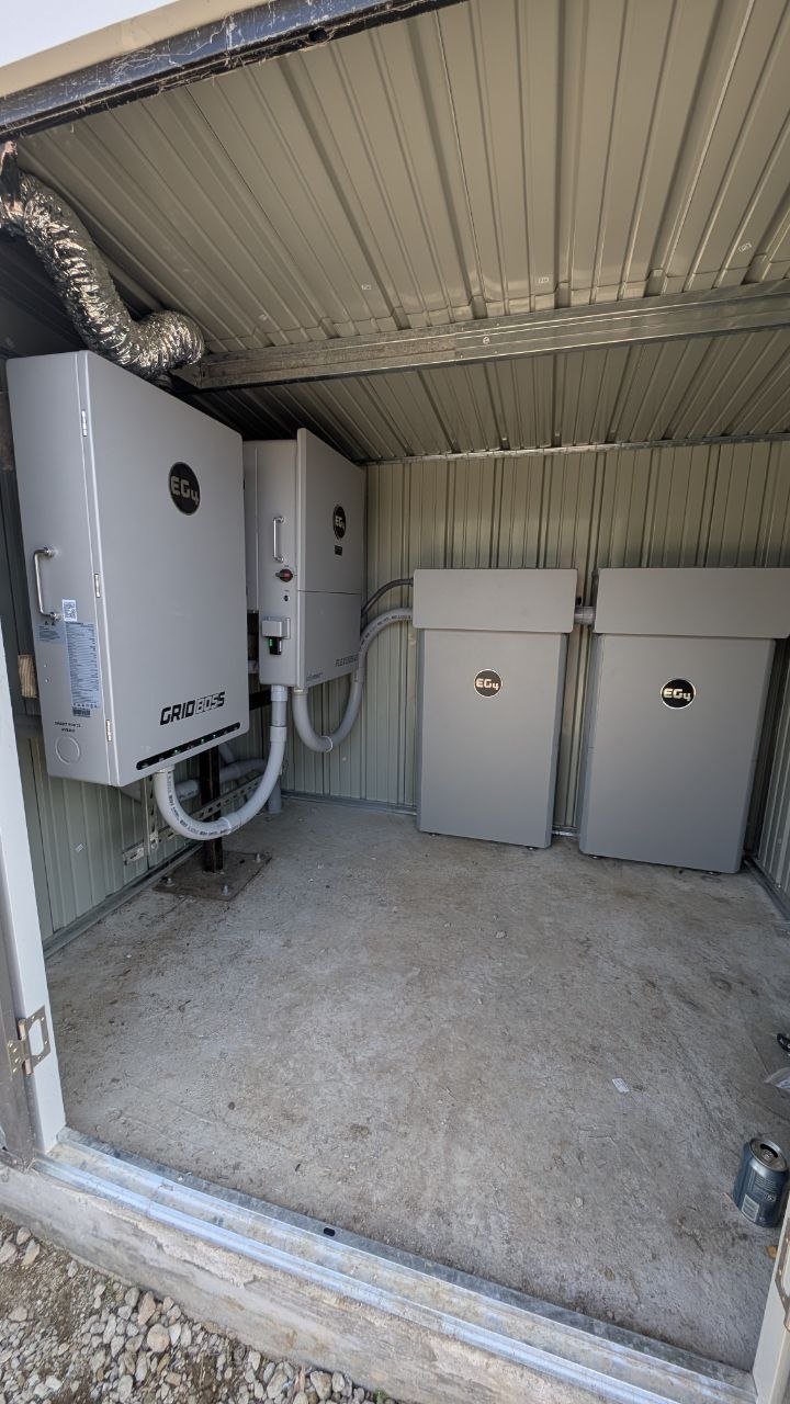 EG4 GridBoss inverter and dual EG4 battery units inside the custom utility enclosure
