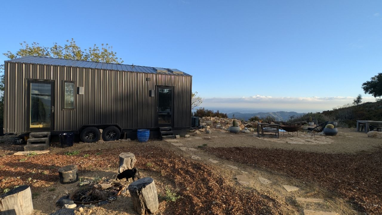 Corrugated steel tiny home perched on the ridge with panoramic Ojai valley views