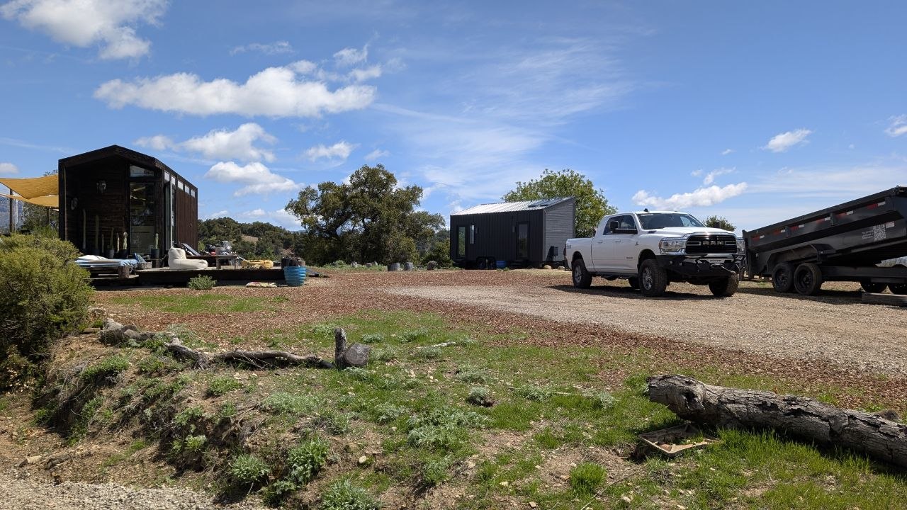 Both custom tiny homes placed across the open terrain of the 40-acre Ojai retreat