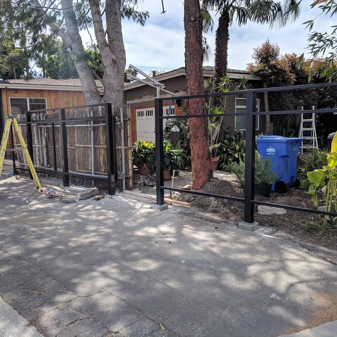 Initial construction phase of custom driveway gate with natural wood siding