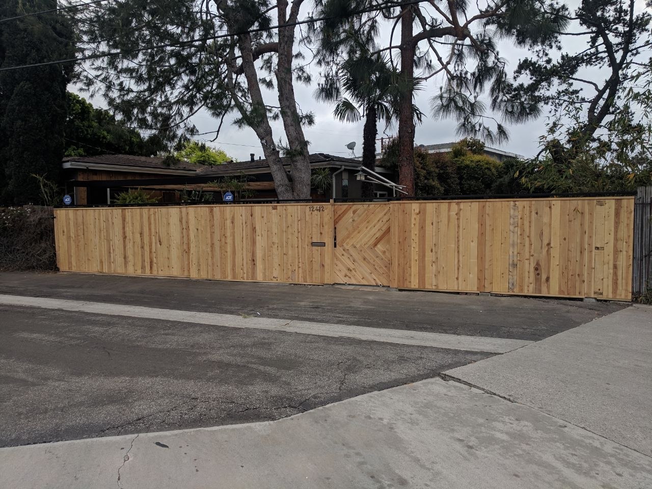 Finished solid wood privacy fence along street